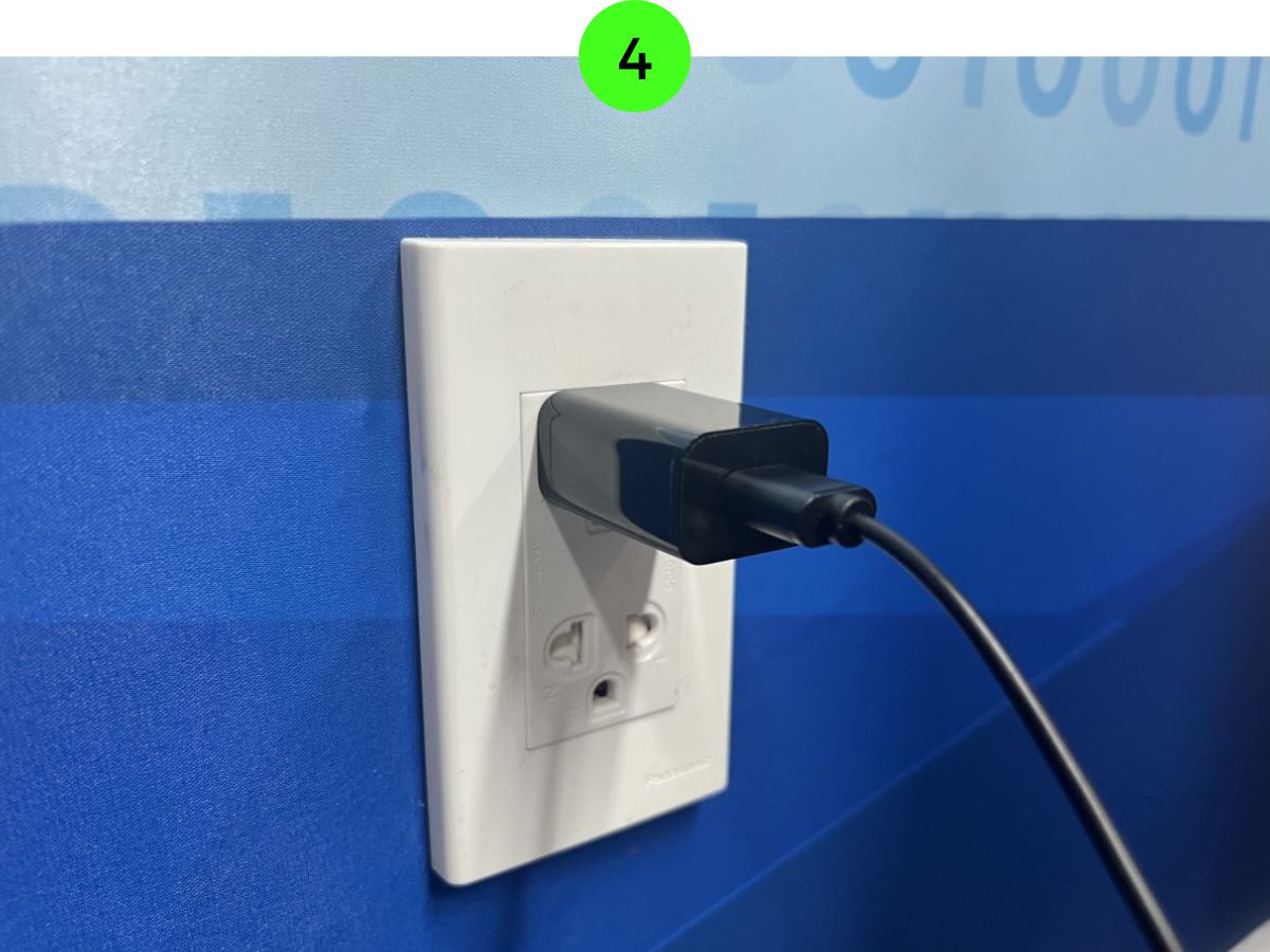 Fire TV Stick's power adapter is plugged into an electricity outlet