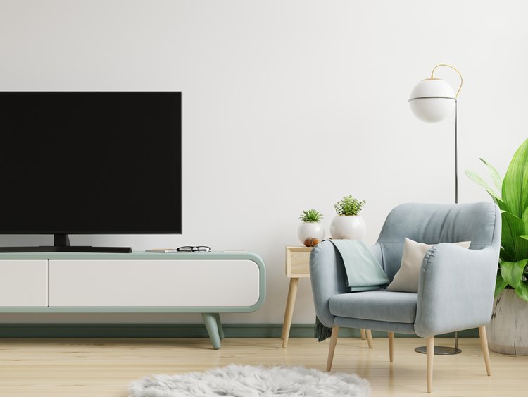 Smart TV in a living room with a small sofa