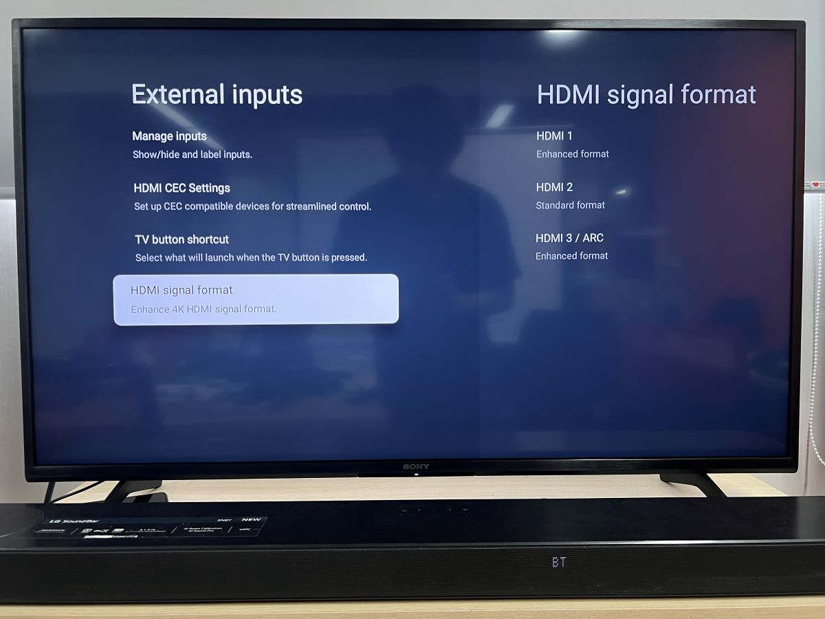 Sony TV with a soundbar and the TV is showing the HDR 4K format in the settings
