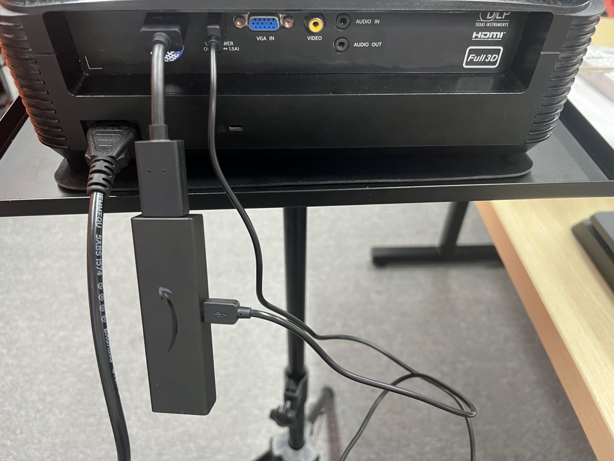 The Fire Stick is plugged into the Optoma projector via HDMI port