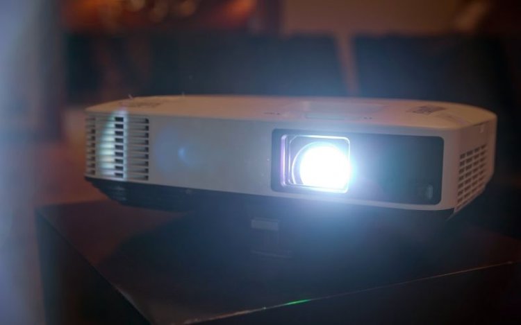 an Epson projector working in a dark room