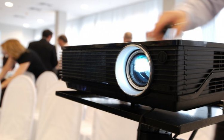 man resets the projector lamp