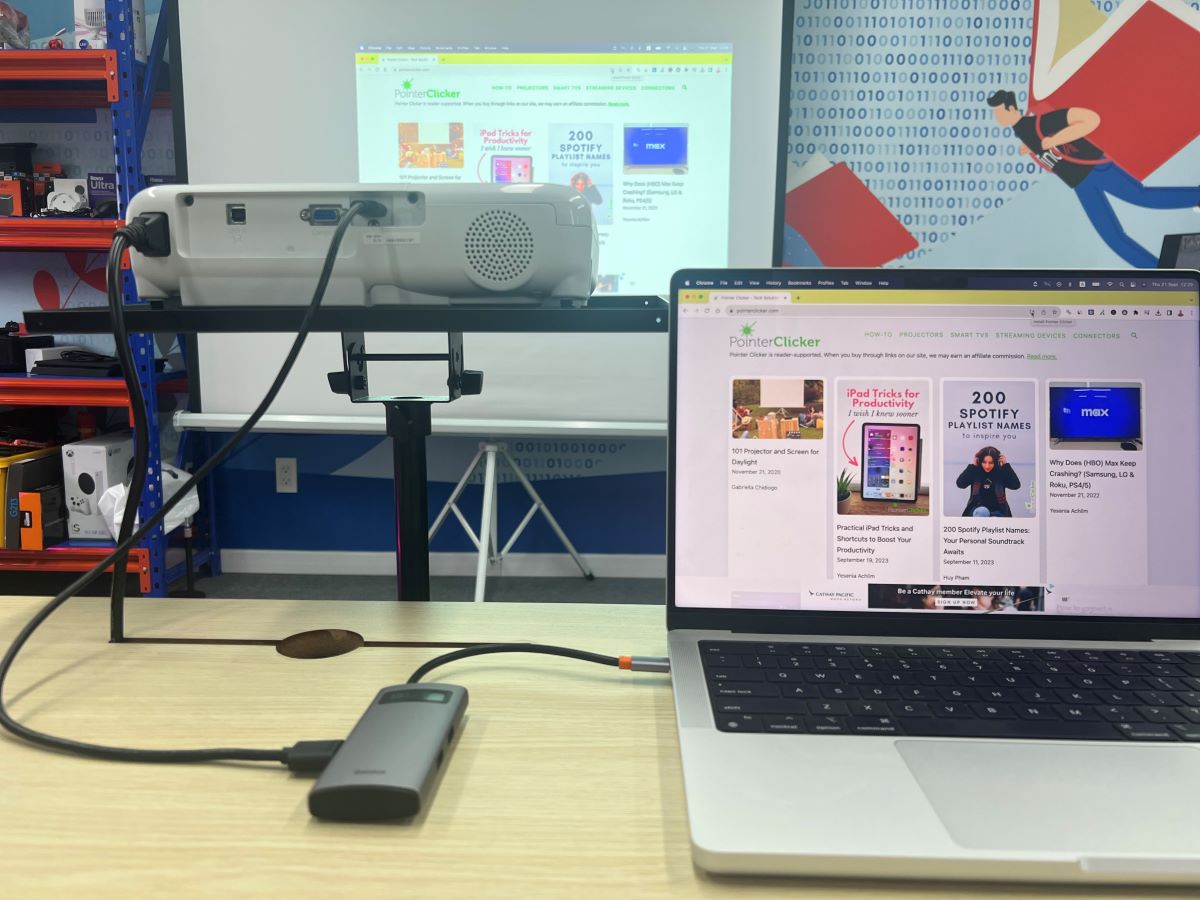 MacBook using USB-C to HDMI adapter connects to Epson projector and showing a website