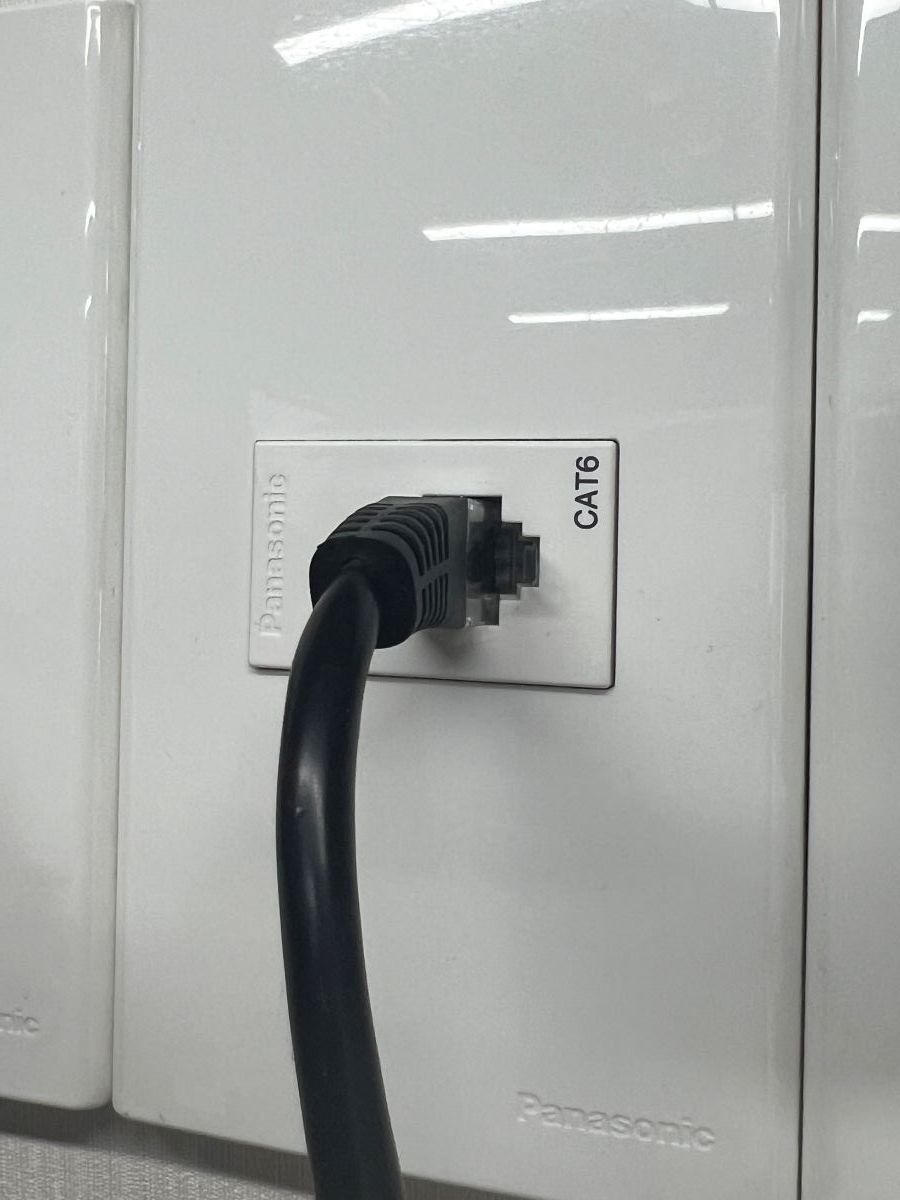 The ethernet cable is plugged to the CAT6 port on the wall