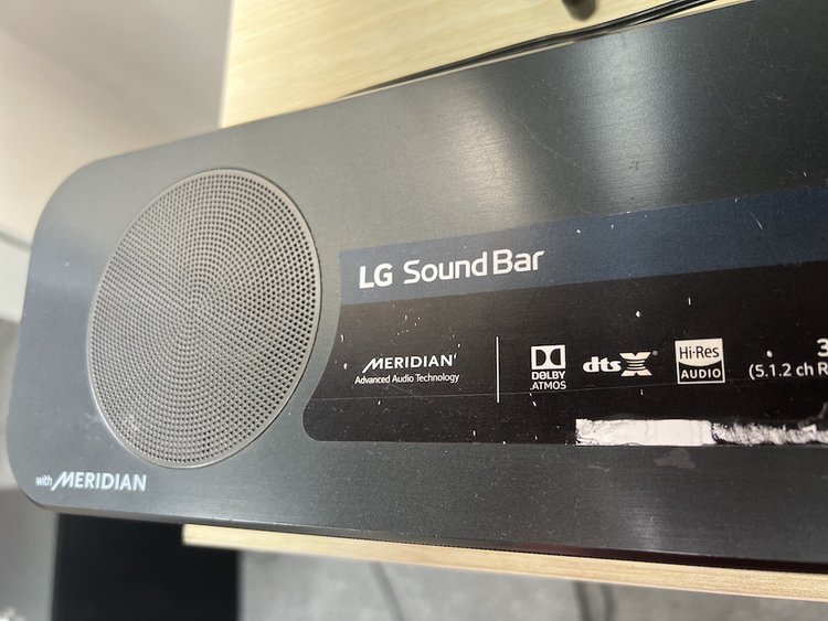 a LG soundbar with dolby atmos on a table