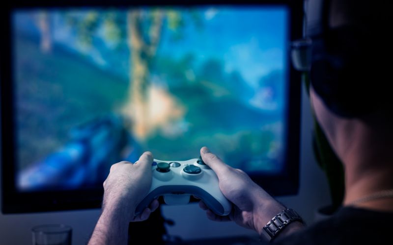 a man is playing games in low resolution content with his gaming console