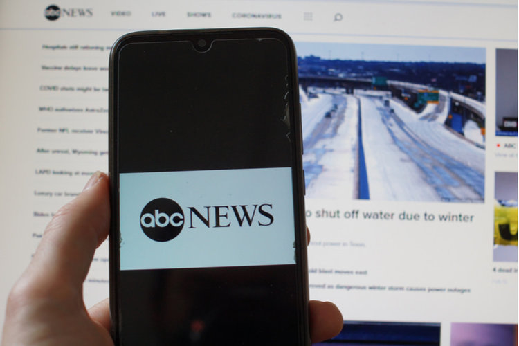 abc news on smartphone and screen