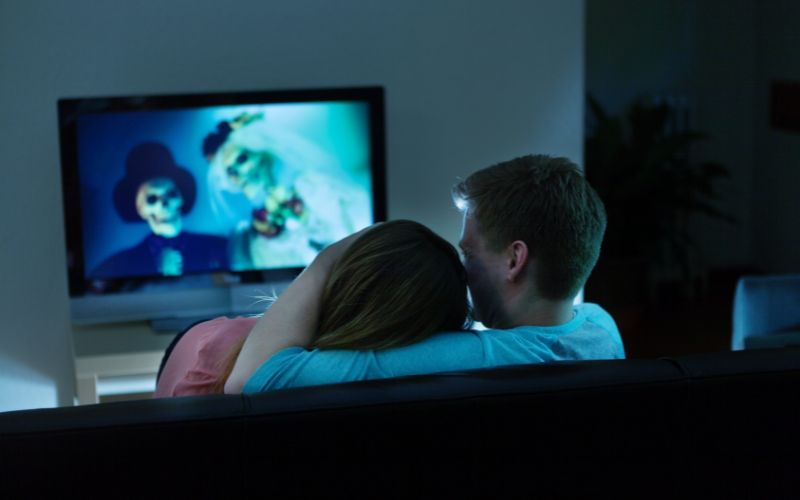 couple watching Halloween movie in a room