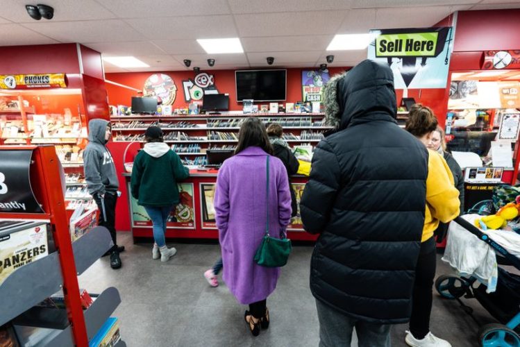 customers queuing at CeX store in front of selling counter