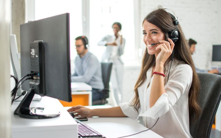 girl smiling while supporting customer via phone