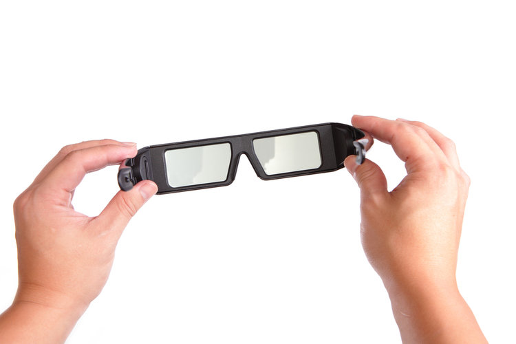 holding a pair of 3d glasses