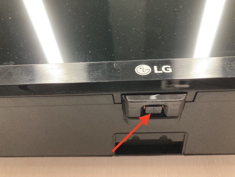 the power button at the bottom of the LG smart TV