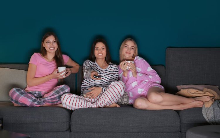 three girls wearing pajamas at movie night