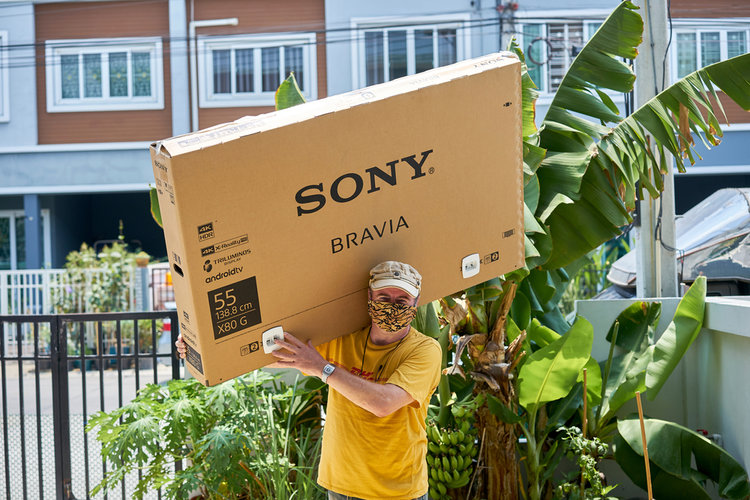 55-inch TV carried by a man