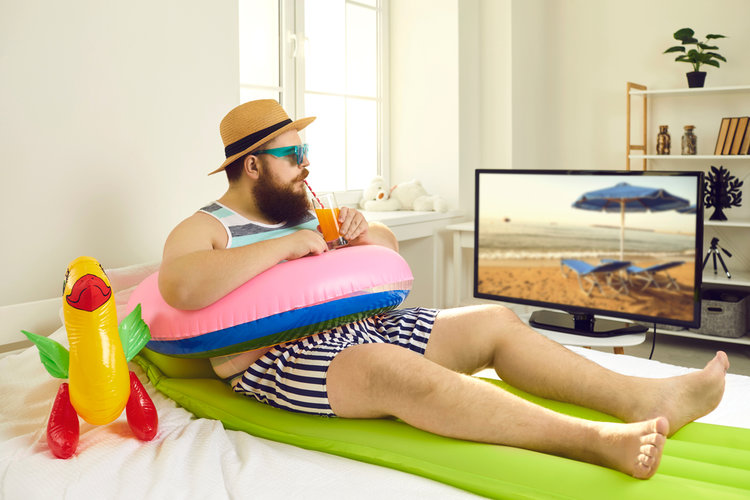 A man watching TV with sunglasses