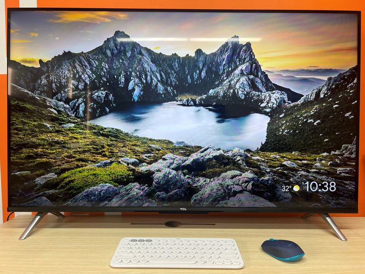 Logitech wireless keyboard and mouse with LG TV on a table