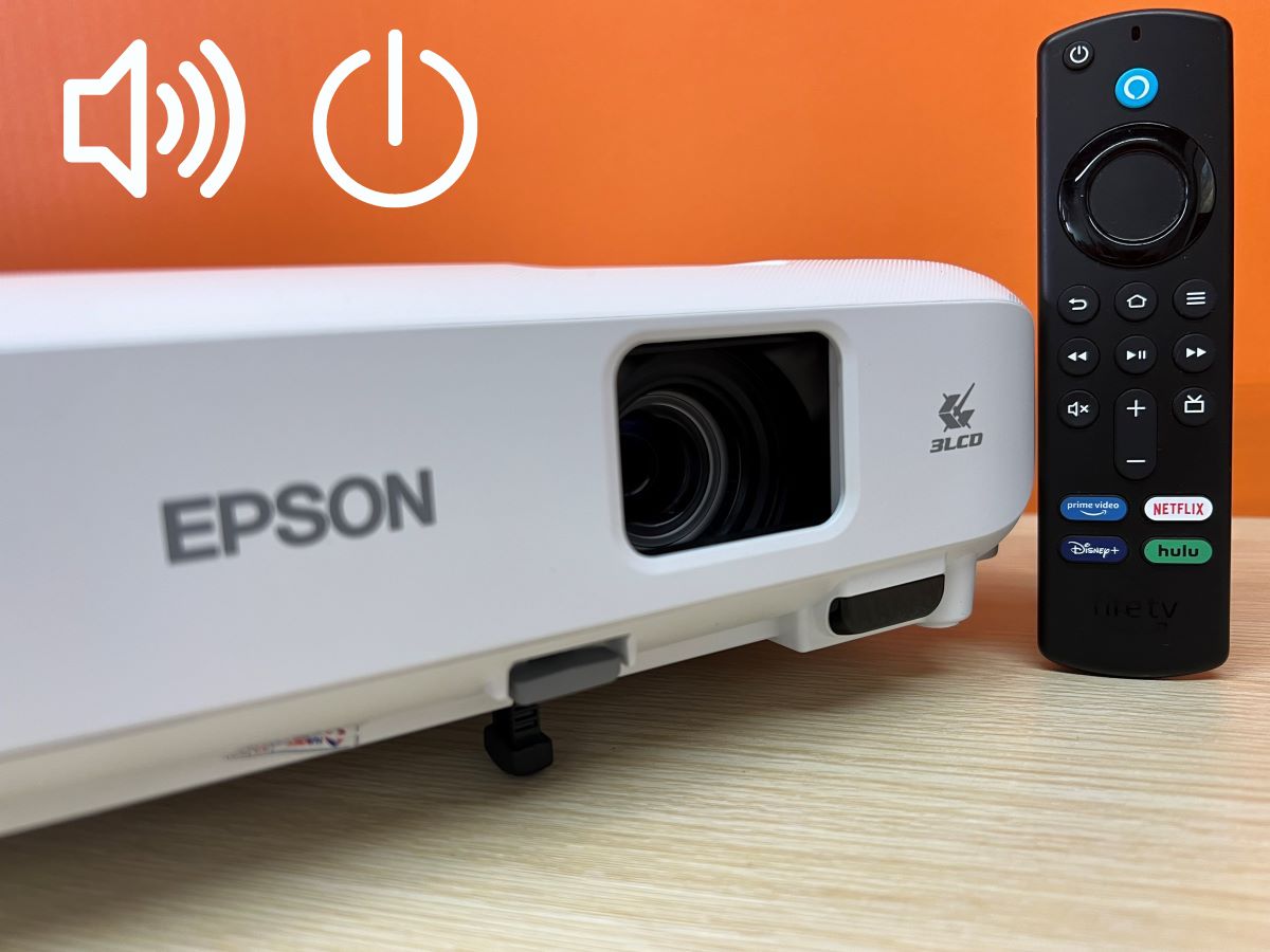 The fire stick remote along side with the Epson projector and the orange background