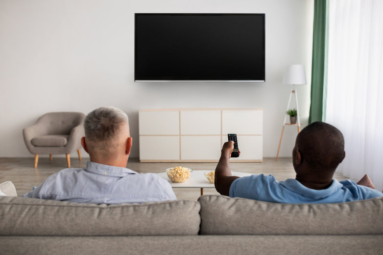Two men watching TV