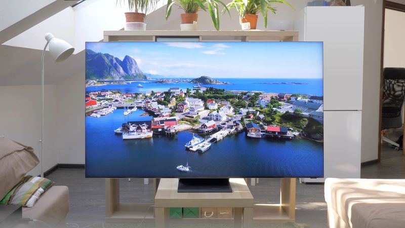 a QLED TV with landscape screen on in the living room