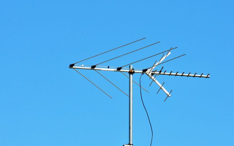 a TV antenna in blue sky