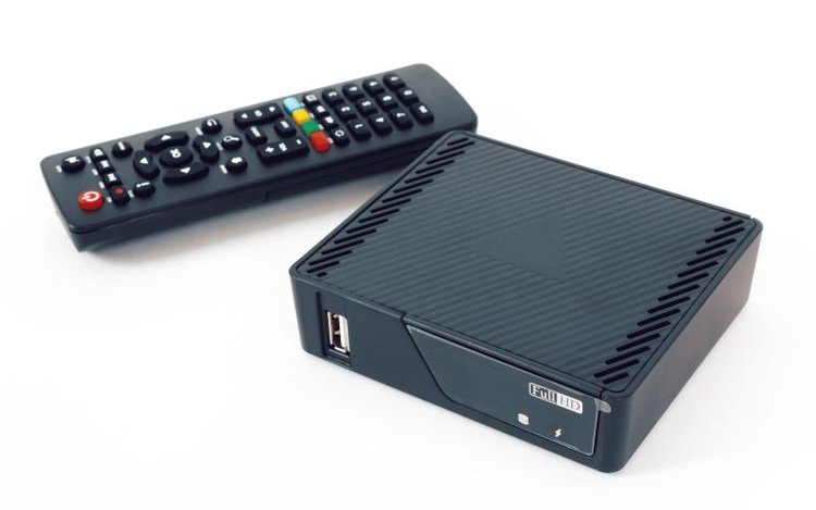 a black Android TV box and its remote
