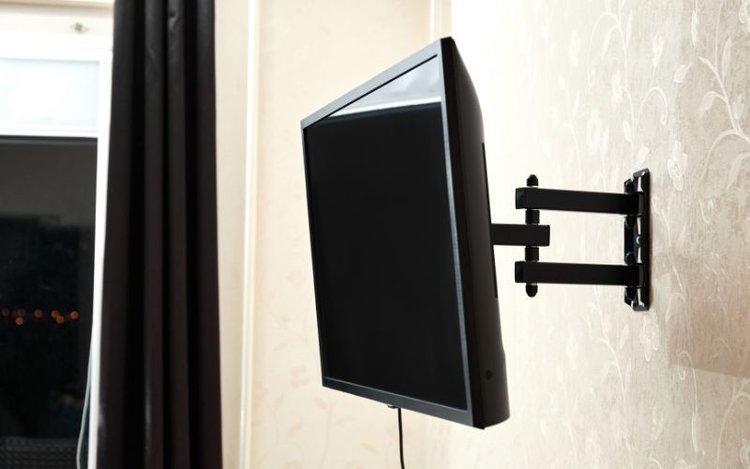 a black TV mounted on the wall