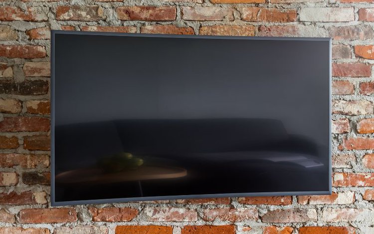 a curved tv is mounted on the wall