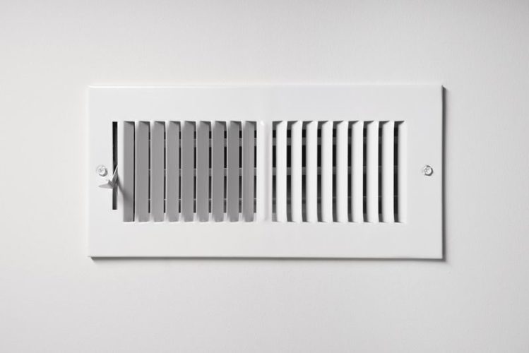 a heat vent on the wall of a home