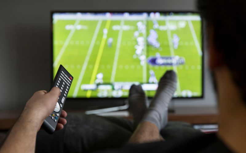 a man watching football on the TV