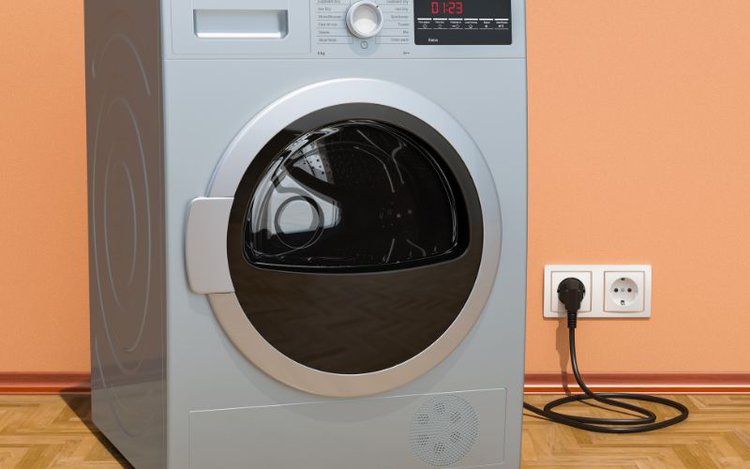 a washing machine plugged into wall outlet