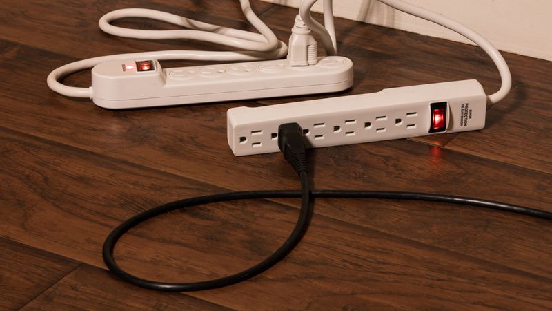 a white power strip plugged into another white power strip