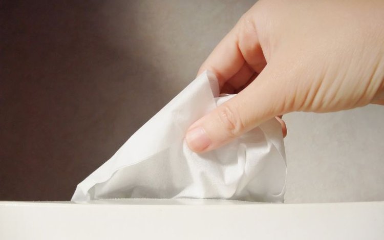 hand picking up tissue paper