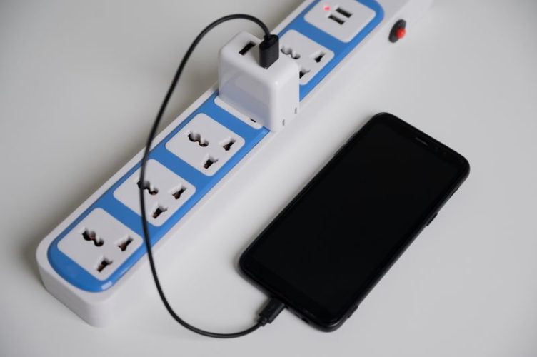 smartphone being charged on a power strip