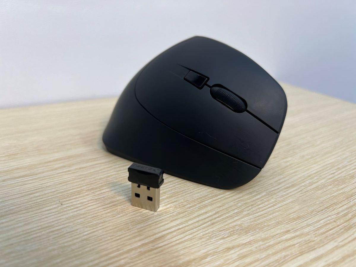 A mouse with a receiver on a wooden table