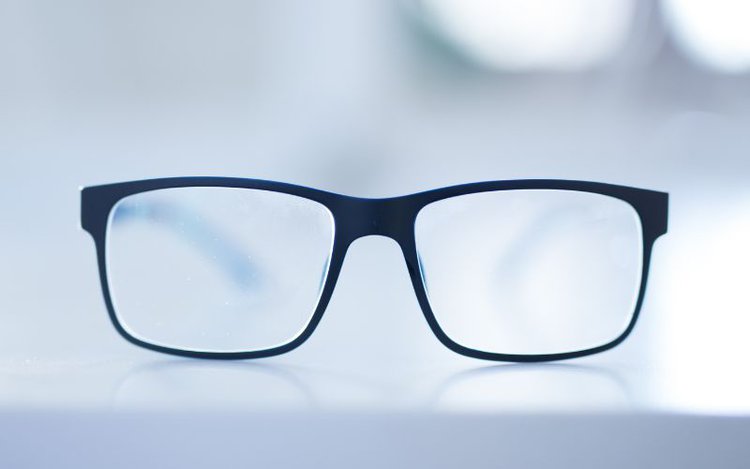 a pair of reading glasses in a blur background