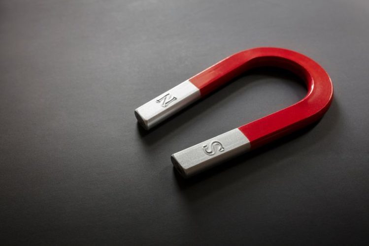 a red magnet in grey background