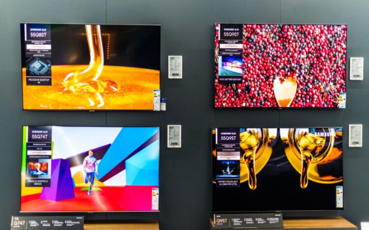 a set of four flat-screen smart UHD Samsung TVs in a store