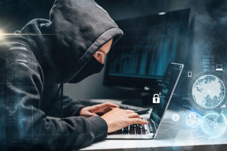 hacker stealing personal information on laptop