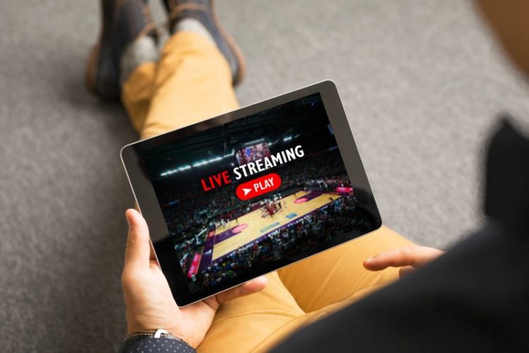 man watching sport live streaming on his tablet