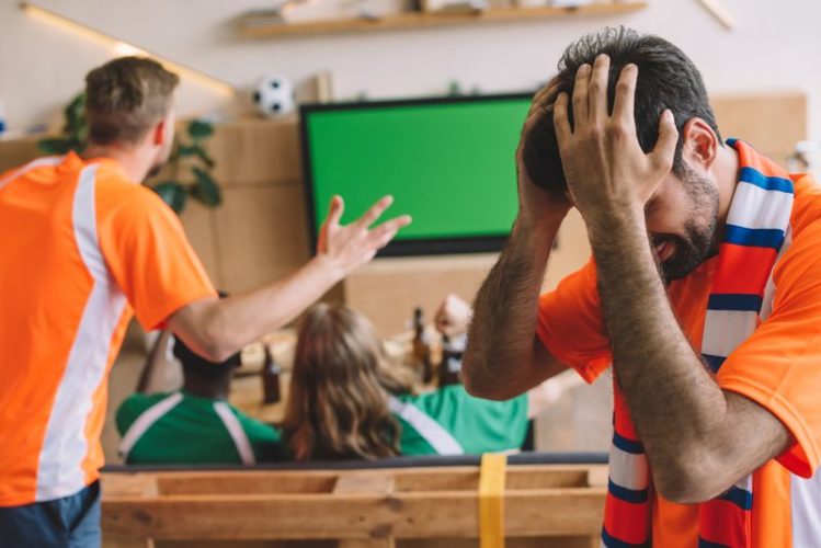 people frustrated with TV screen turning green while watching football