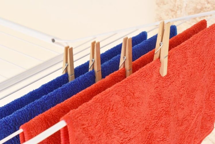red and blue microfiber cloths hanging to dry on drying rack