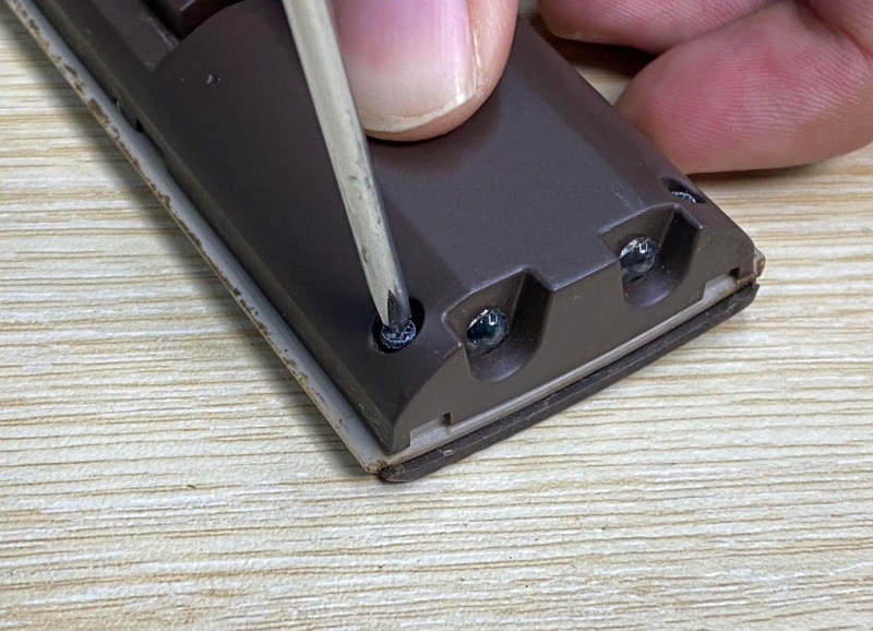 use a screwdriver to unscrew screws on a TV remote control