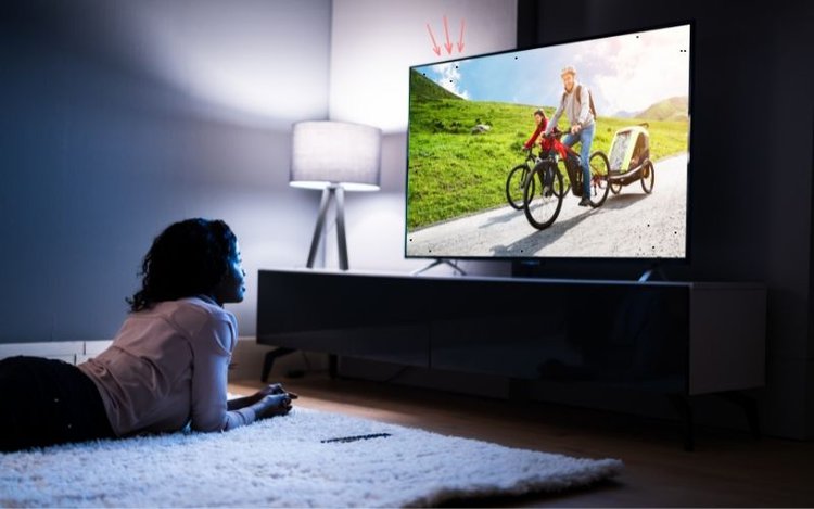 woman is watching a LED TV affected by dead pixels