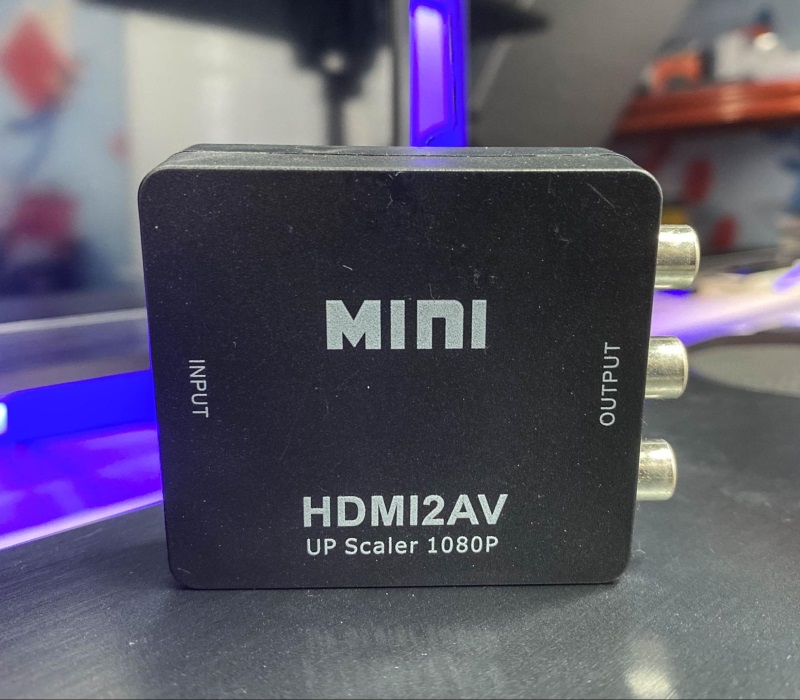 MINI HDMI to RCA converter placed in front of a smart TV