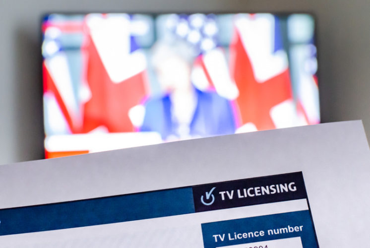a TV license with news channel on the background