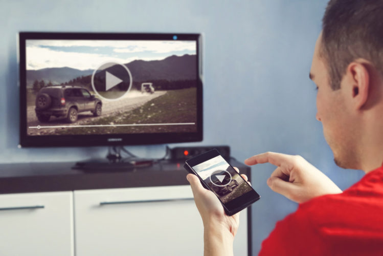 man casting video from his phone to TV