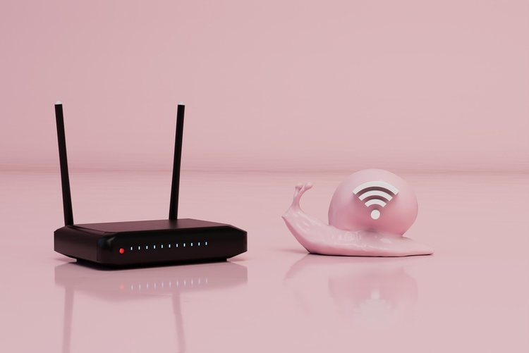 slow wi-fi concept with a snail crawling towards black wi-fi router