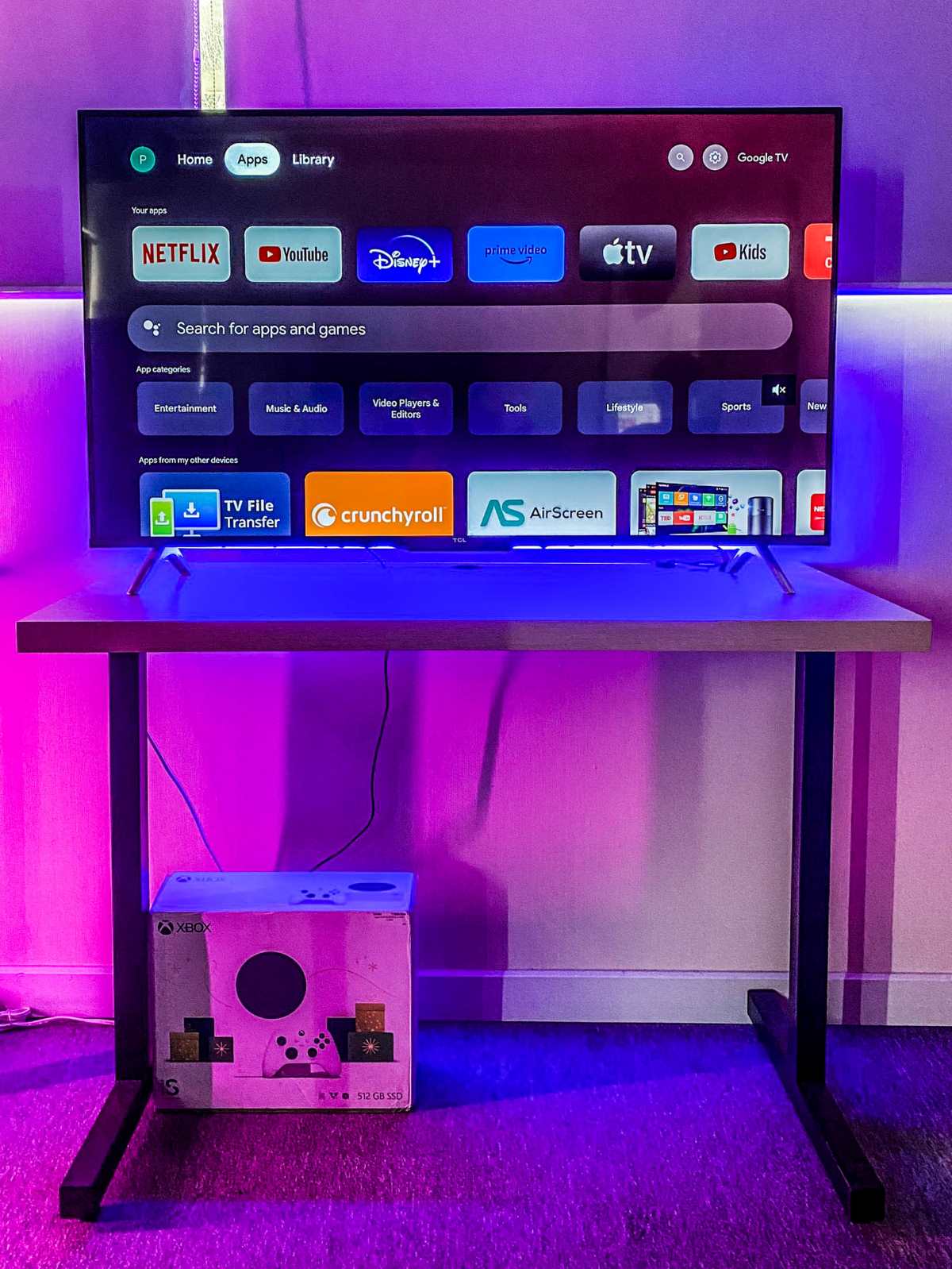 the TCL Google TV is placed on a high-leg table