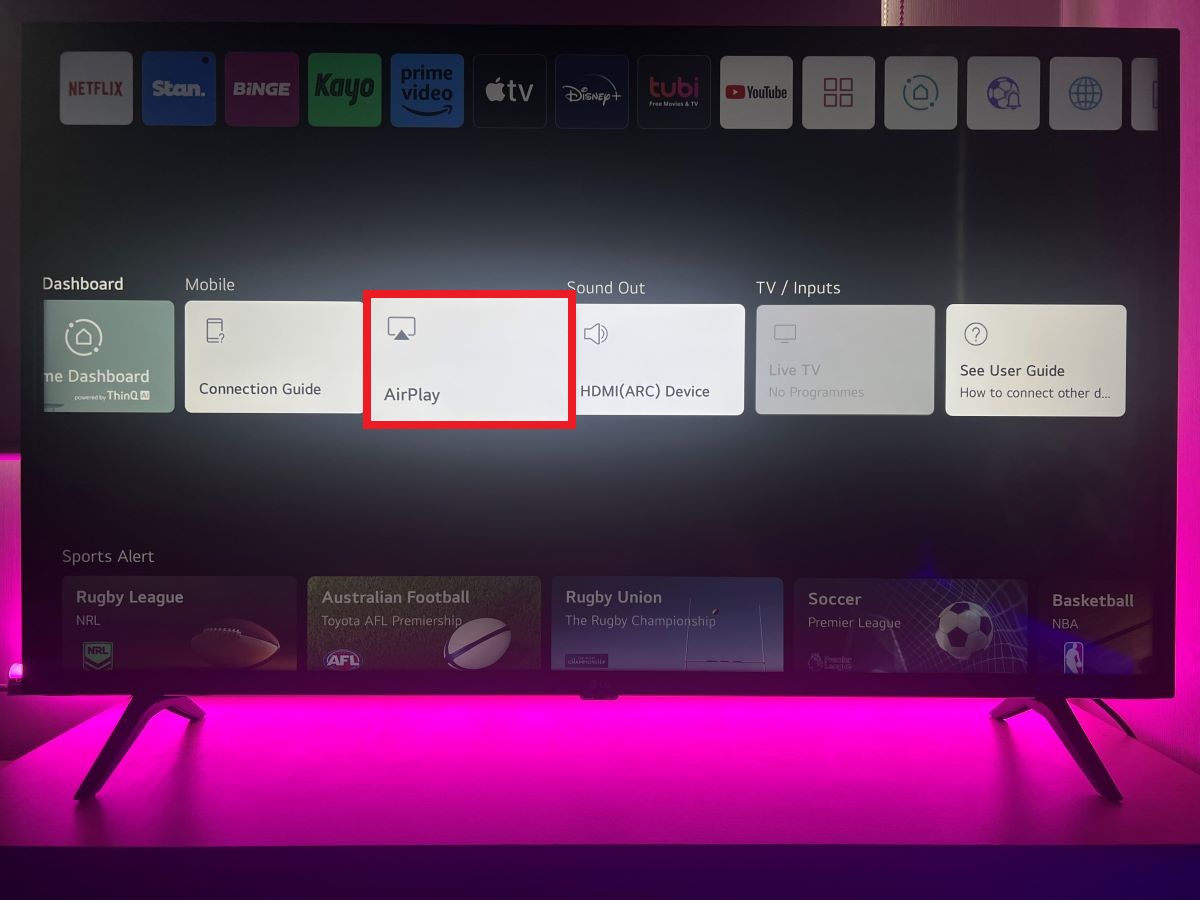 AirPlay feature on LG TV with a pink light background