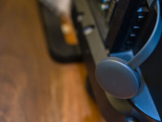 Google Chromecast device is plugged into a port on the back of TV